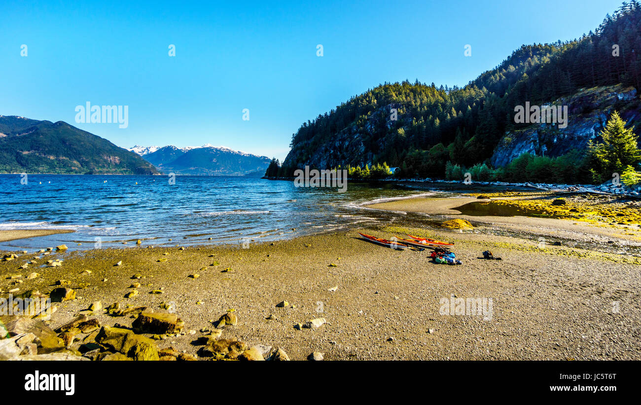 Kayakers ready to explore the waters of Howe Sound and surrounding mountains. Viewed from the Porteau Cove ferry docks in beautiful BC, Canada Stock Photo