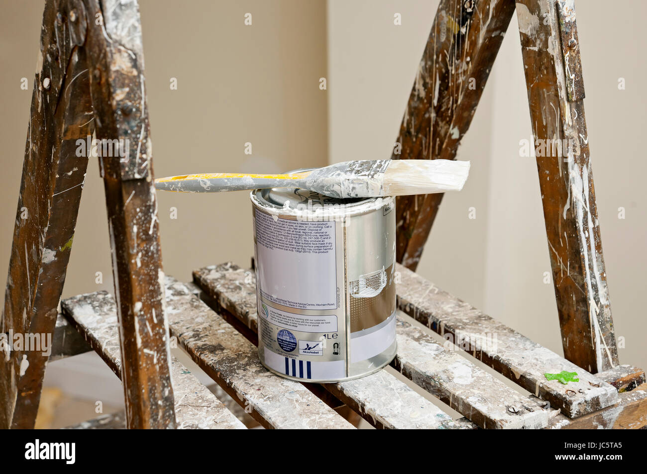 Close up of paintbrush paint brush and can tin of paint on stepladders Stock Photo