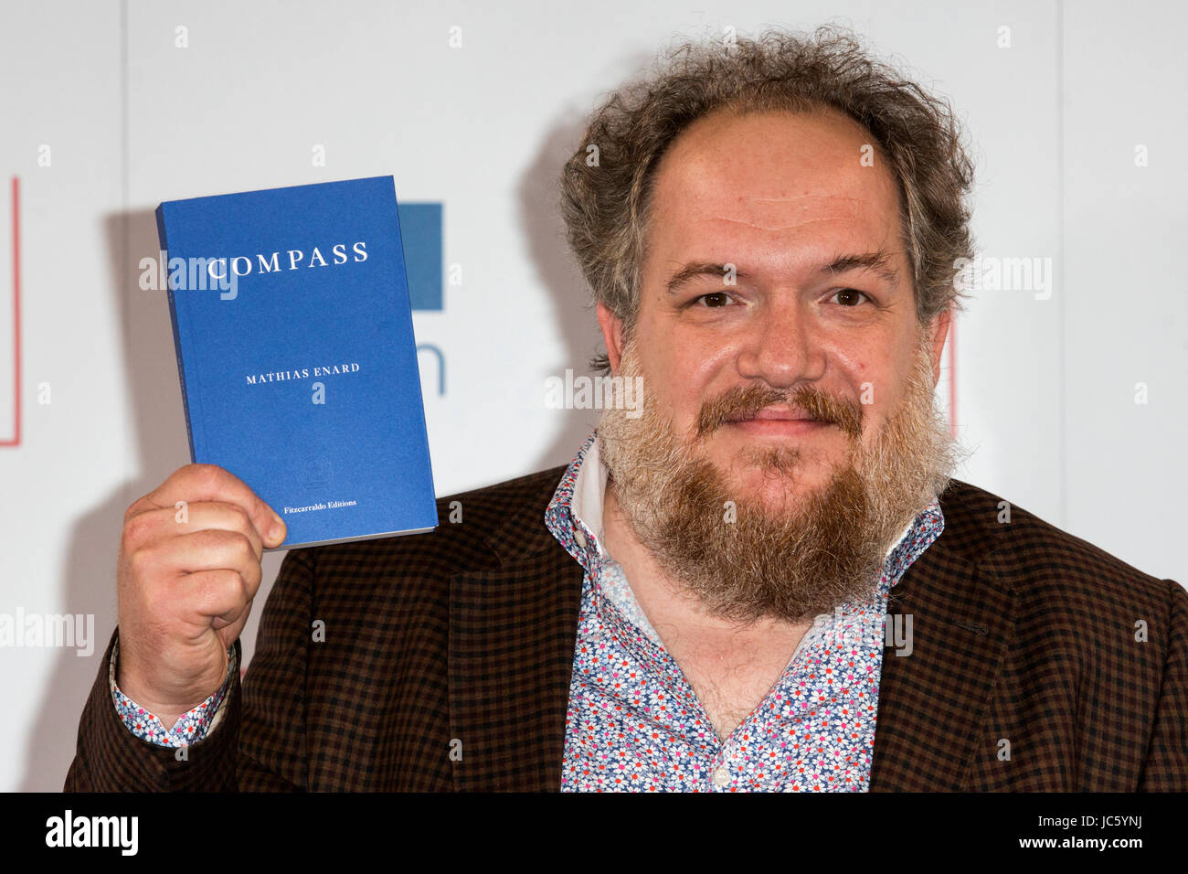 London, UK. 13 June 2017. Pictured: French writer Mathias Enard with his book Compass. Photocall with the shortlisted writers and their translators for the 2017  Man Booker International Prize. Stock Photo