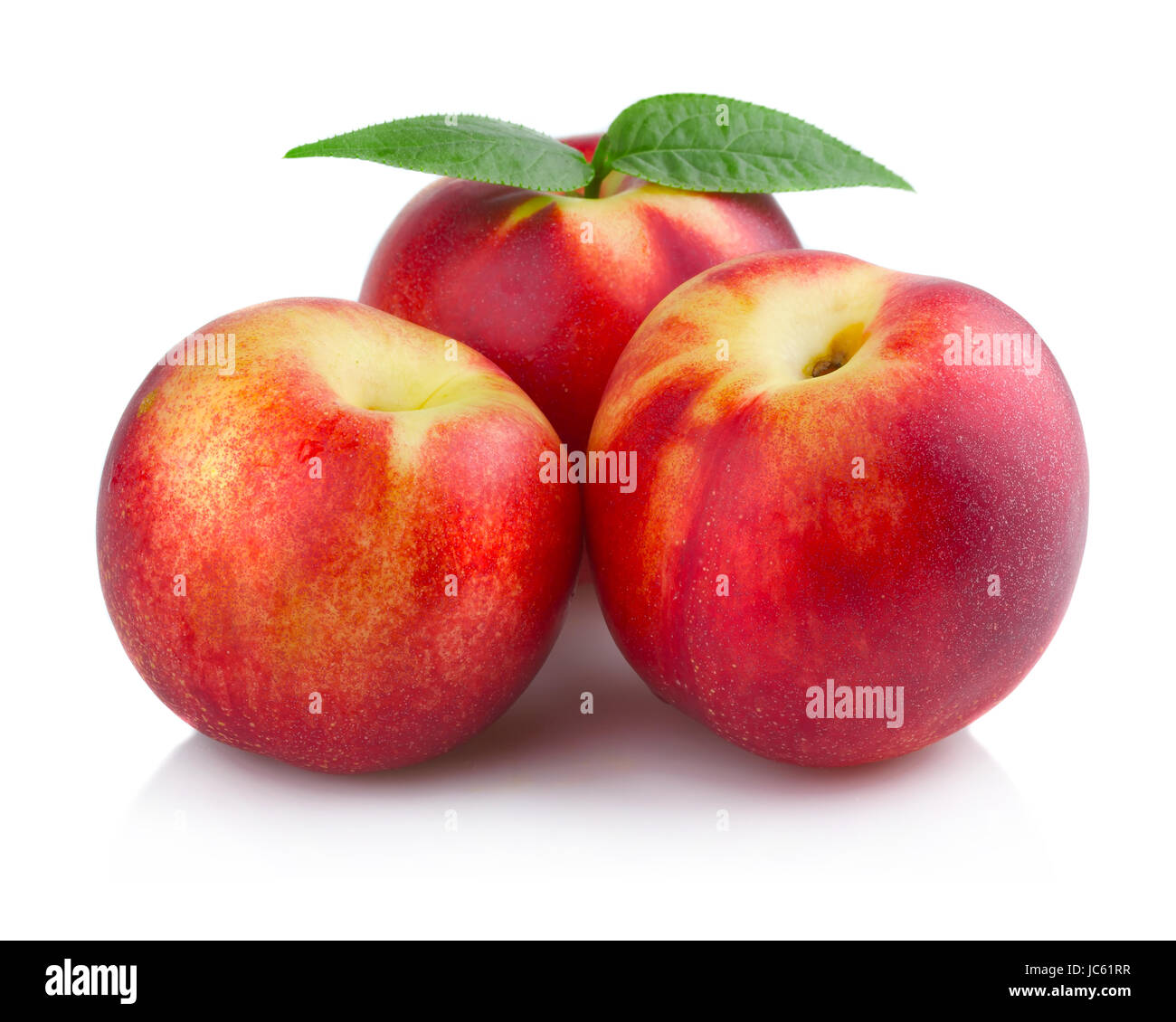 Three ripe peach (nectarine) fruits isolated on white background Stock Photo