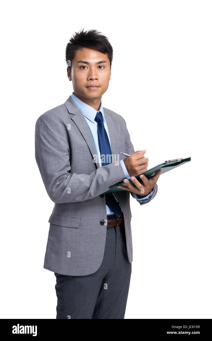 Asian businessman write on clipboard Stock Photo - Alamy