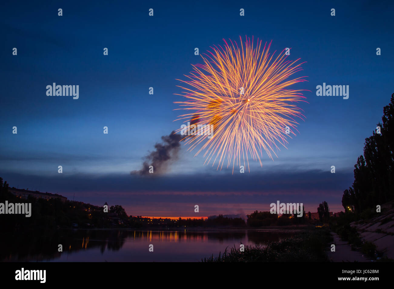 Fireworks Over Lake at Night Stock Photo