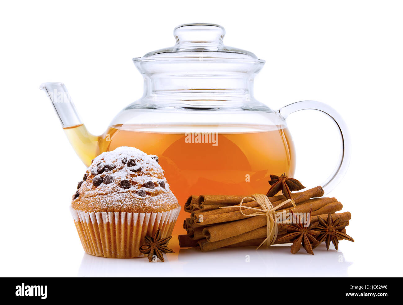 Glass teapot with spices and cake isolated on white background Stock Photo