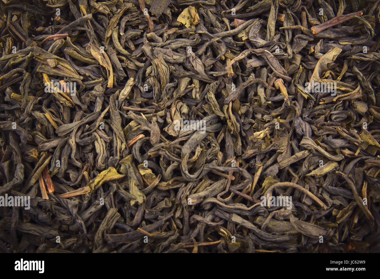 Heap of dry green tea (texture). Macro shot. Stock Photo
