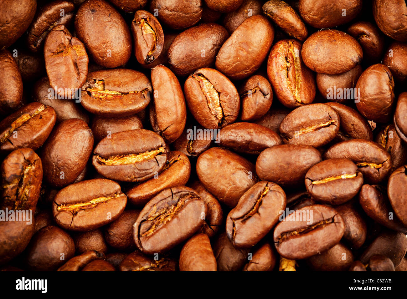 Roasted coffee beans extreme closeup background Stock Photo