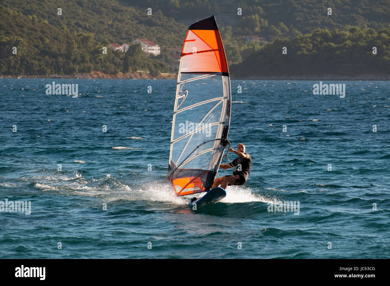 Surfer before Korcula, Dalmatia, Croatia / island and town, Surfer vor Korcula, Dalmatien, Kroatien / Insel und Stadt Stock Photo