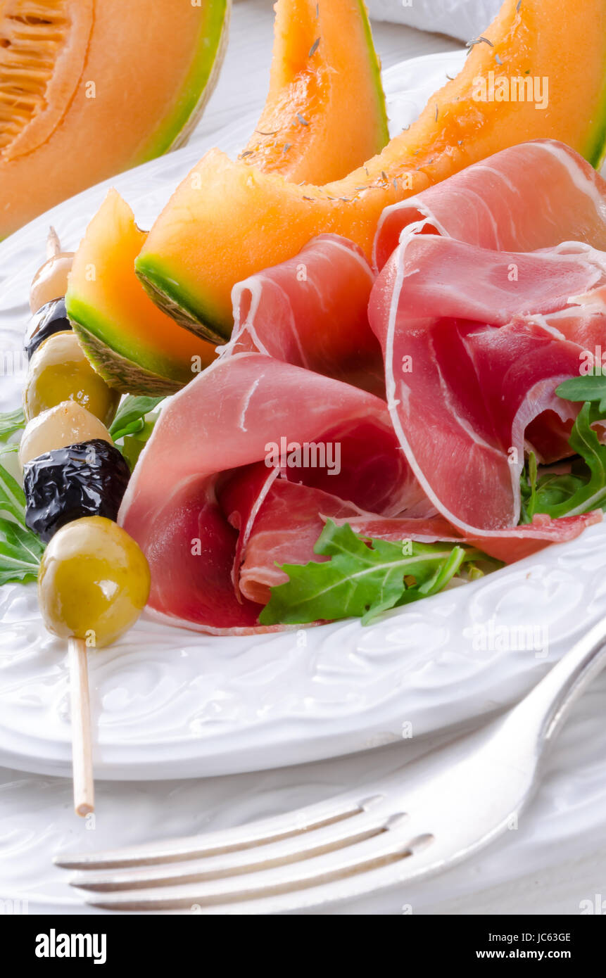 Ham with melon and olives Stock Photo