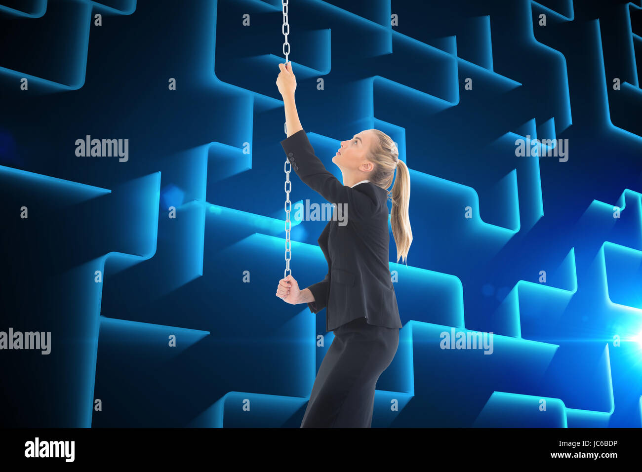 Composite image of blonde businesswoman pulling a chain Stock Photo - Alamy