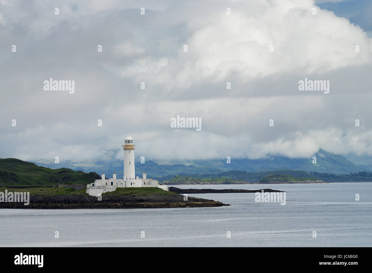 Eilean Musdile Lighthouse on the way to the Isle of Mull in the Inner Hebrides Stock Photo