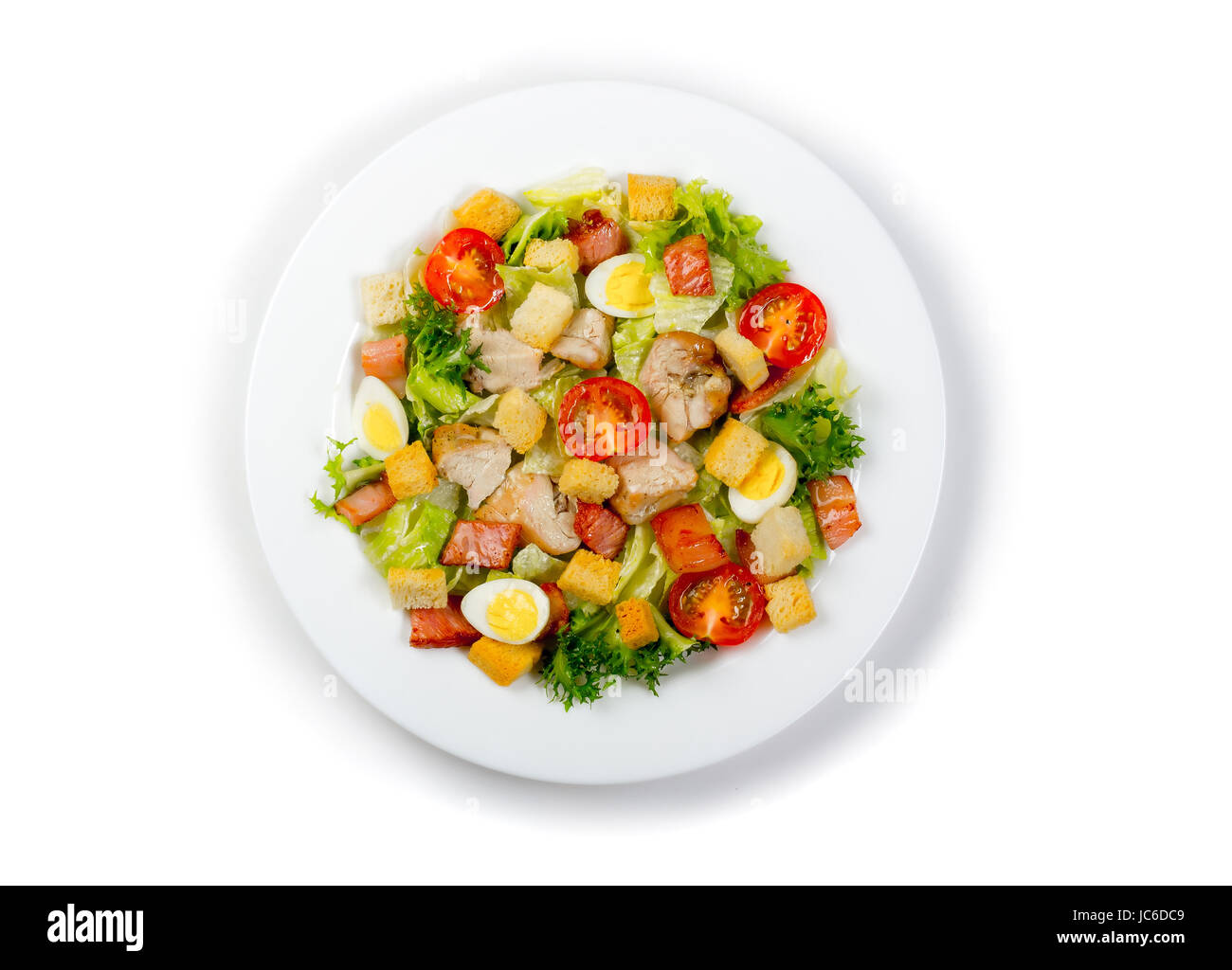 Plate with fresh ceasar salad isolated on white Stock Photo