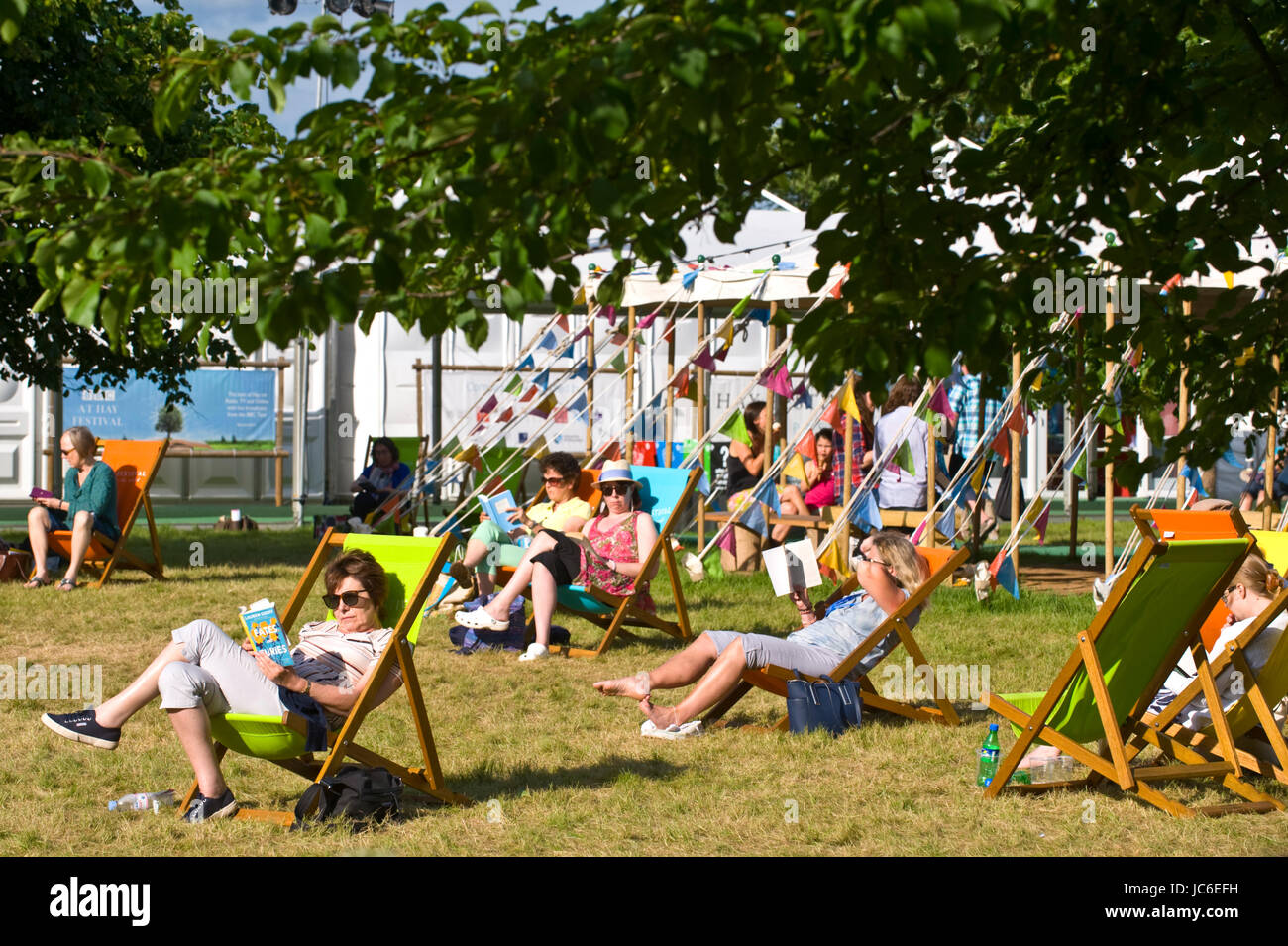 Visitors relaxing in deckchairs at Hay Festival 2017 Hay-on-Wye Powys Wales UK Stock Photo