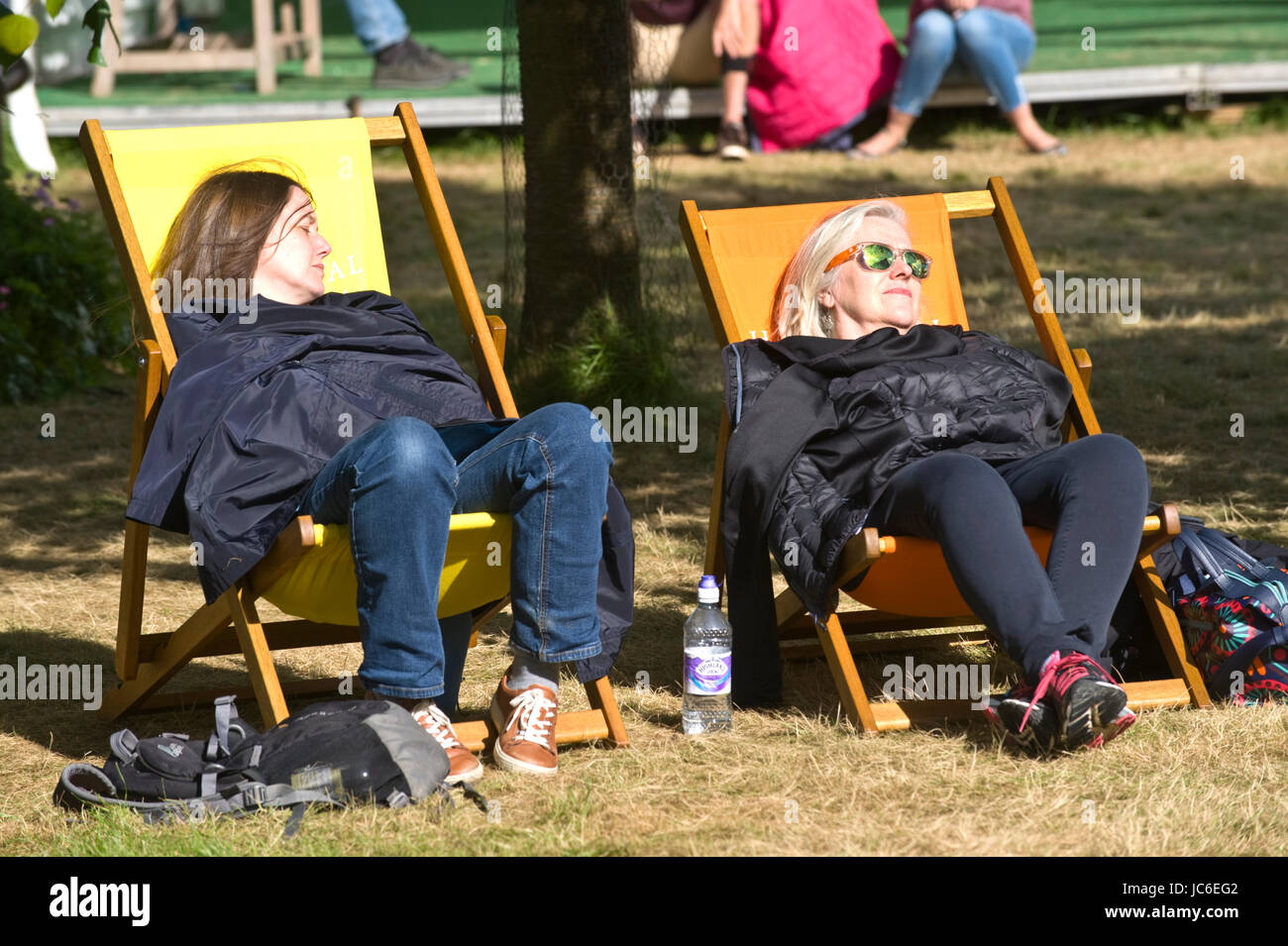 Women asleep in deckchairs at Hay Festival 2017 Hay-on-Wye Powys Wales UK Stock Photo