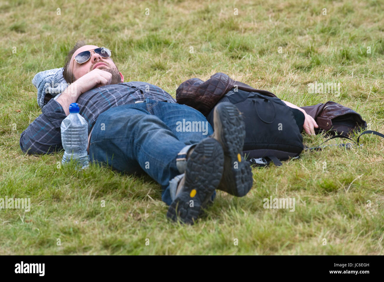 Man asleep on grass at Hay Festival of Literature and the Arts 2017 Hay-on-Wye Powys Wales UK Stock Photo