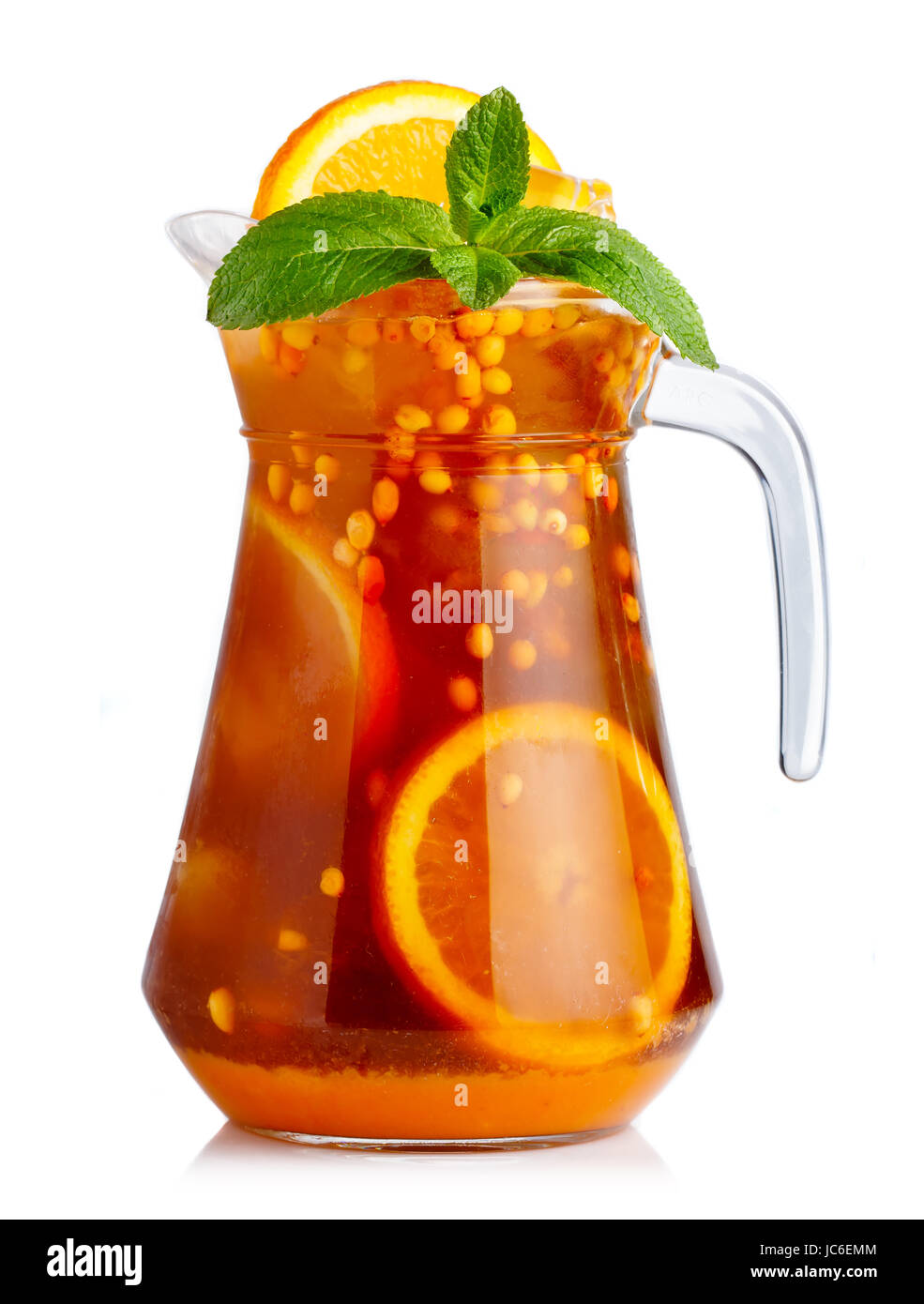 Full jug of nonalcoholic cocktail with orange fruits and sea-buckthorn isolated Stock Photo