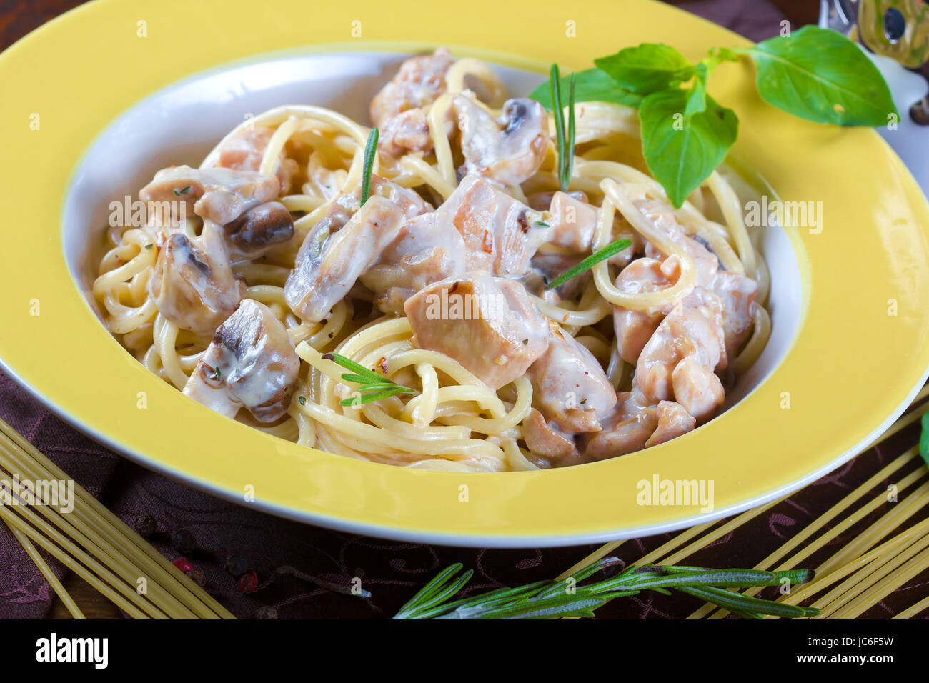Italian pasta with sauce, beef and mushrooms, served on a plate Stock Photo