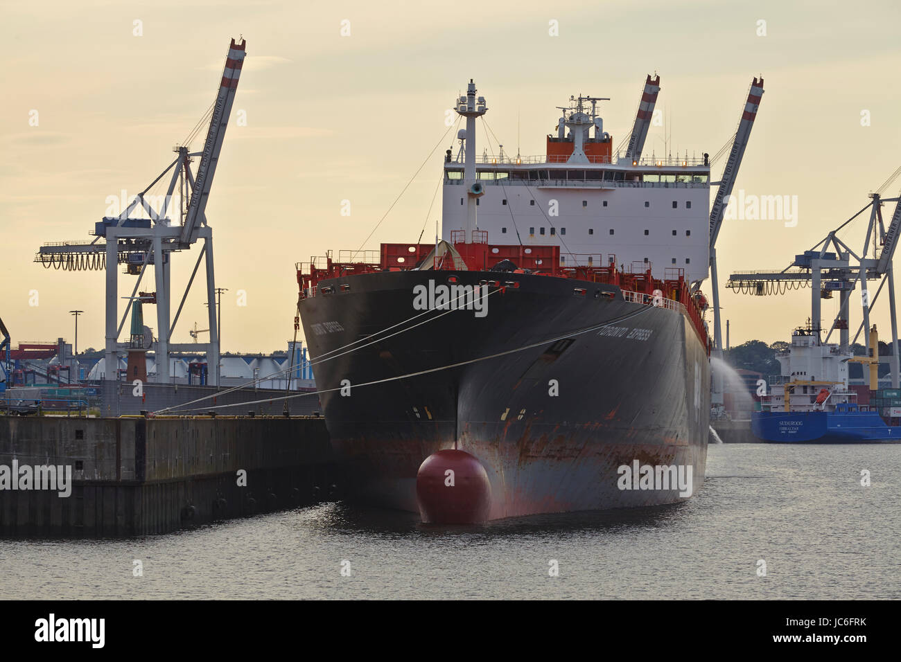 The container vessel Toronto Express in the Ellerholz Port of Hamburg taken with contre-jour on August 8, 2014. Stock Photo