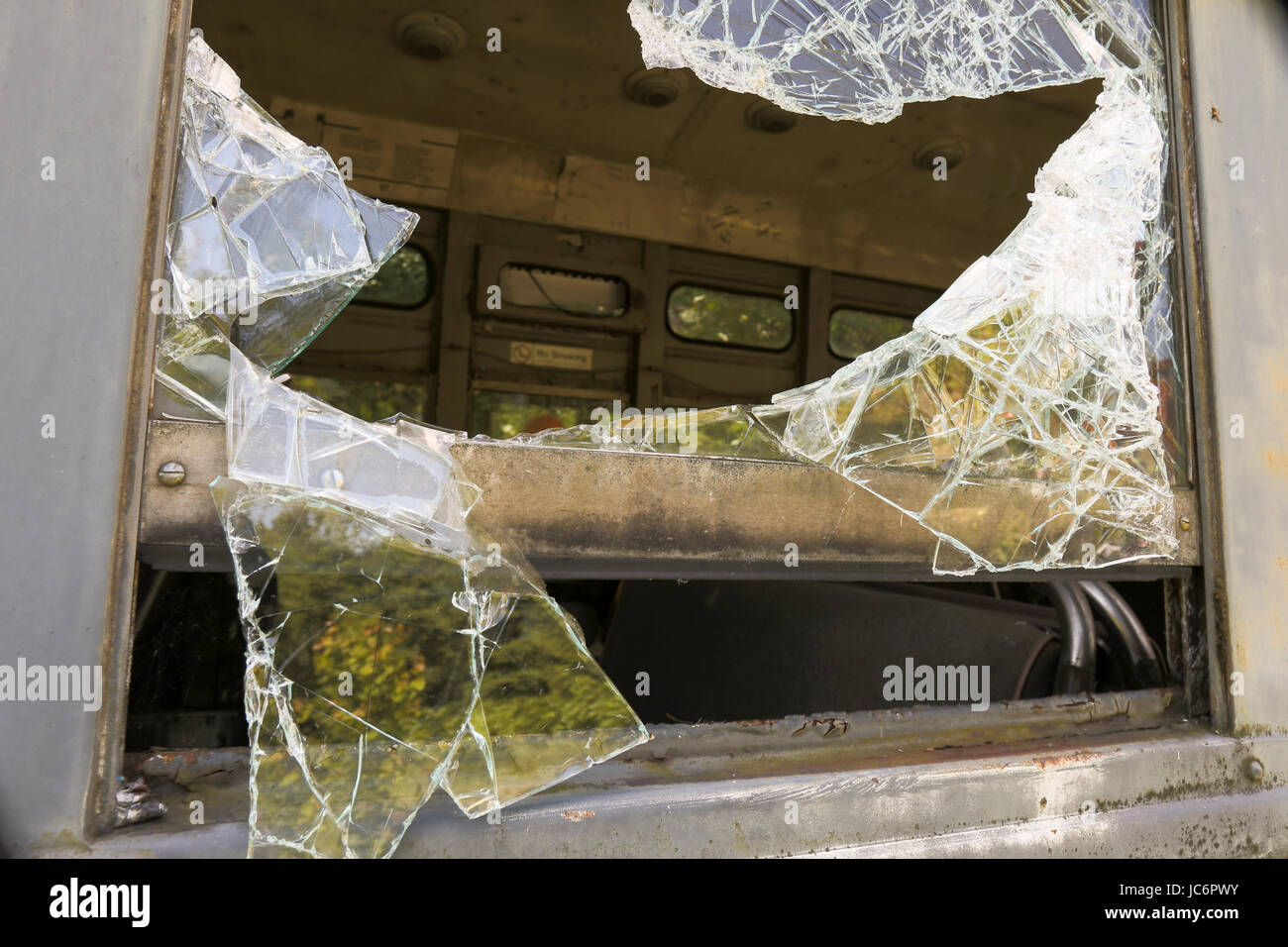 Close up of broken safety glass in window of commuter train car. Stock Photo