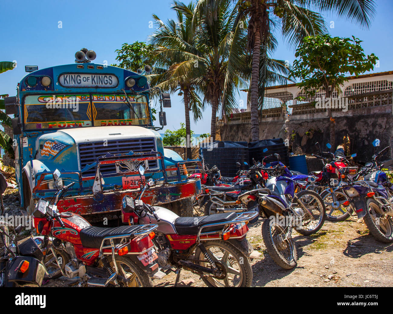 school bus, palm trees, motorcycles Stock Photo