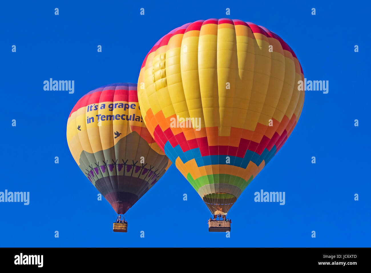 Balloons float over vineyard and Hot Air  Balloon Festival Stock Photo