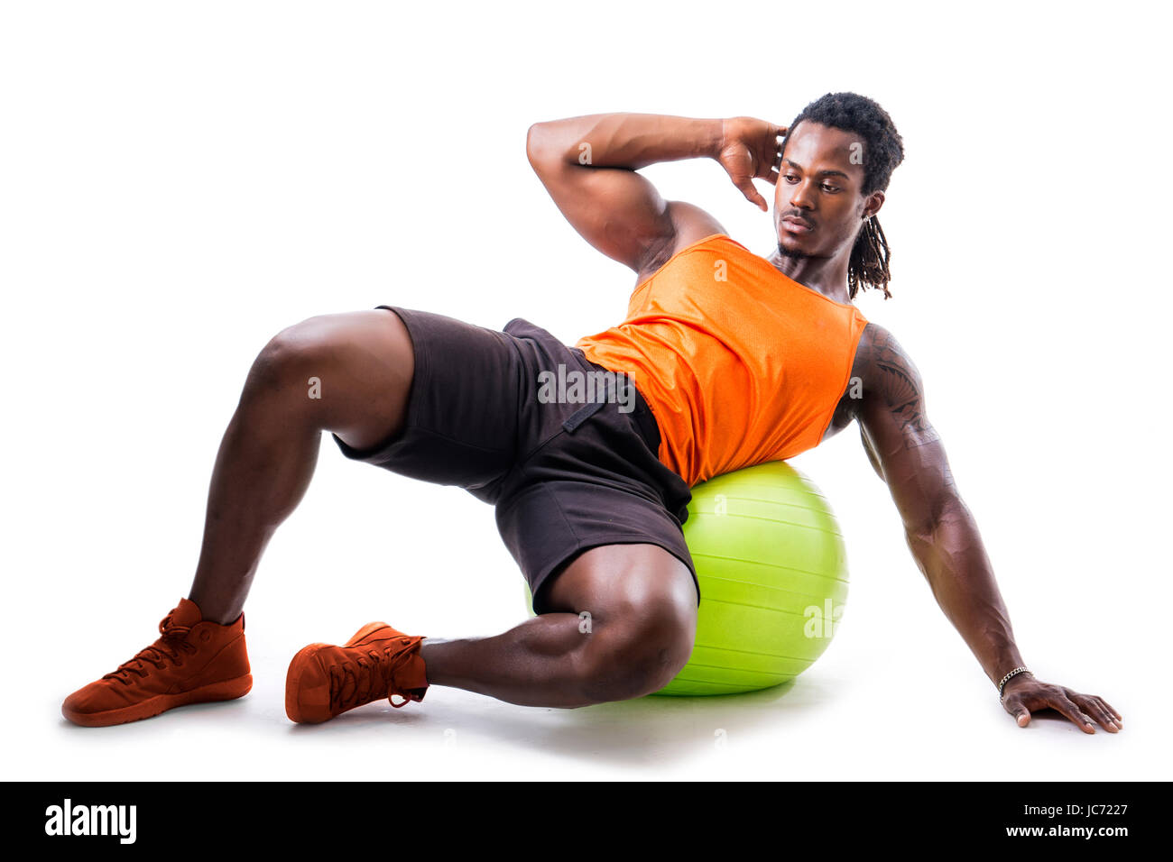 Muscular Man Holding Inflatable Fitness Ball Looking At Camera