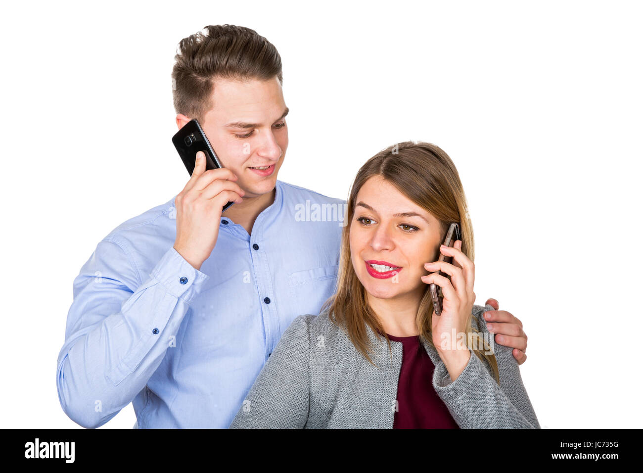 Picture of a young couple talking on the phone, posing on i image picture