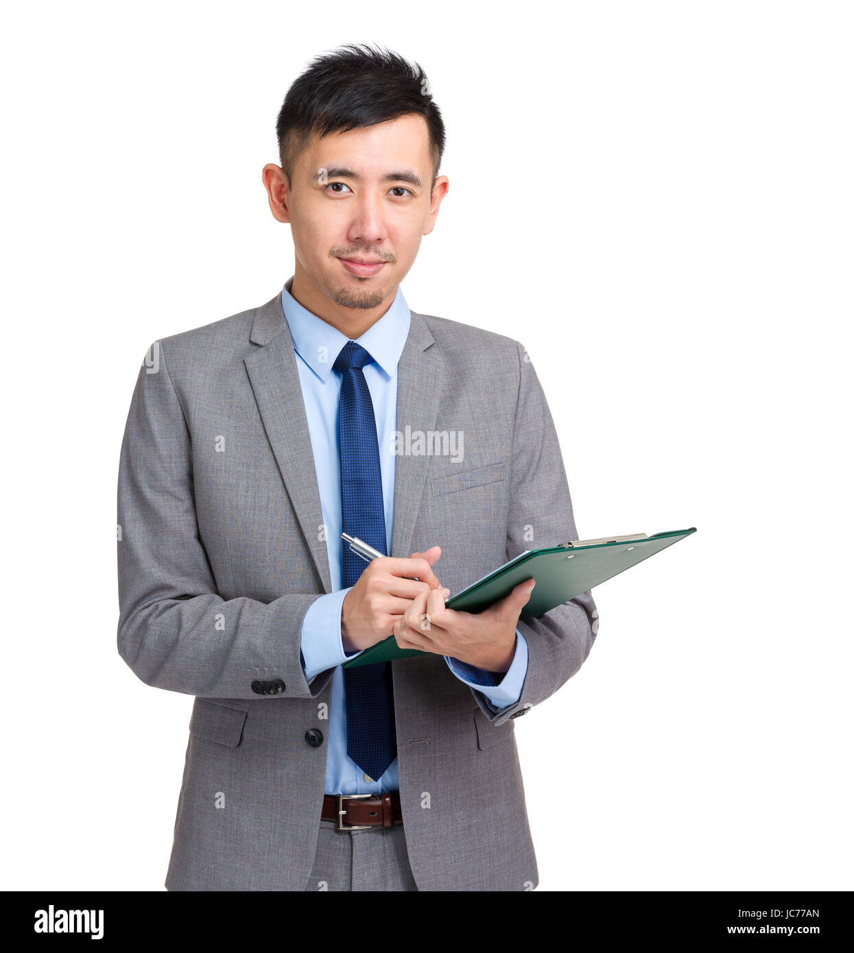 Asian business man write on clipboard Stock Photo - Alamy