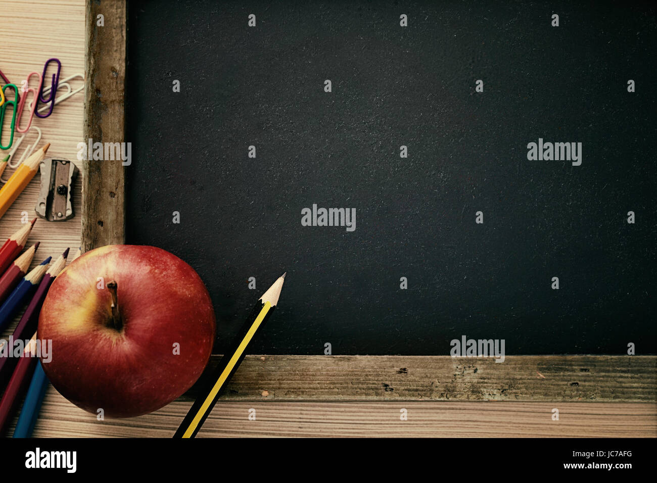 School objects for students. Chalkboard, pencils, crayons and apple Stock  Photo - Alamy