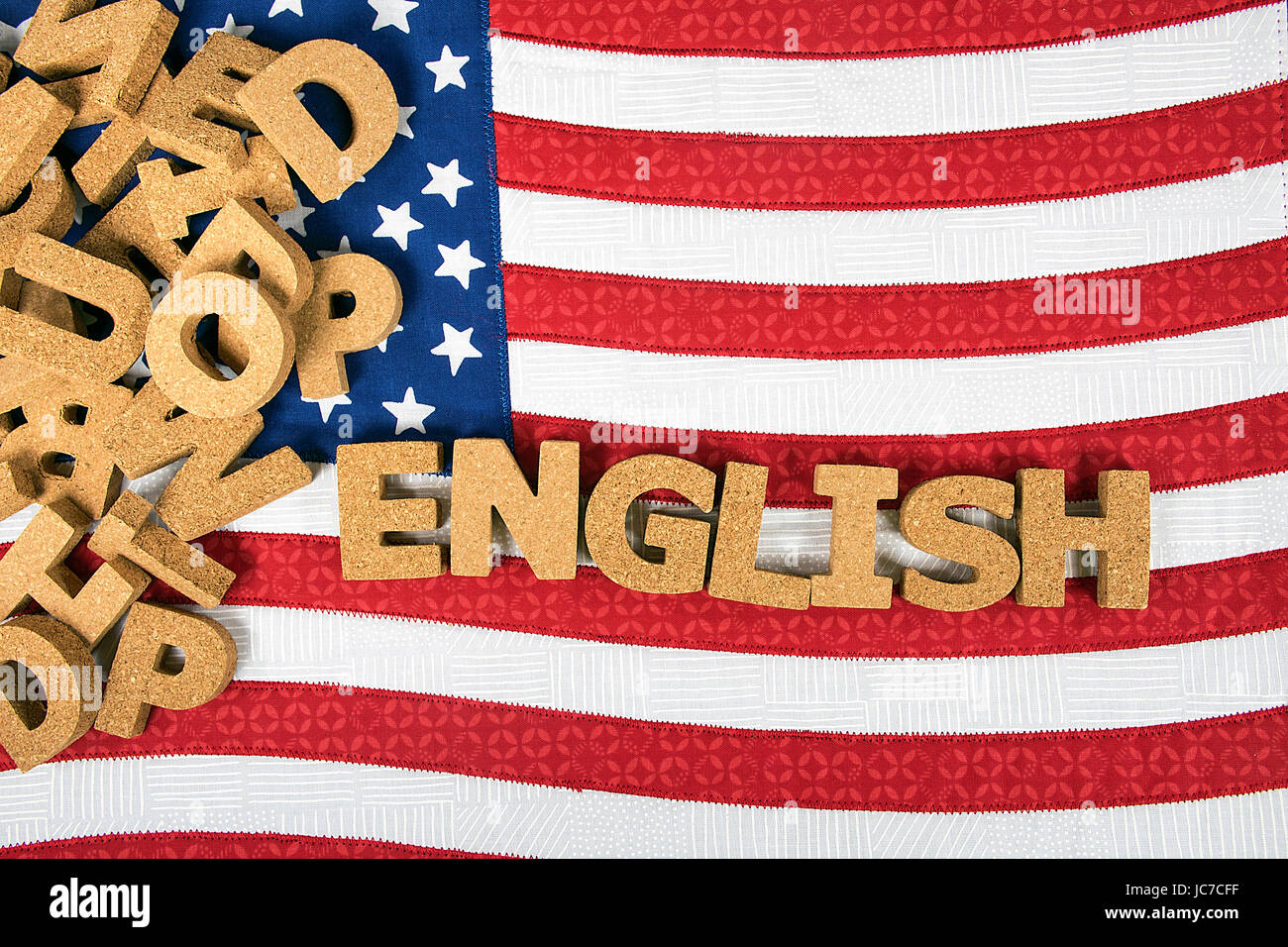 jumbled pile of cork letters on flag with word English Stock Photo