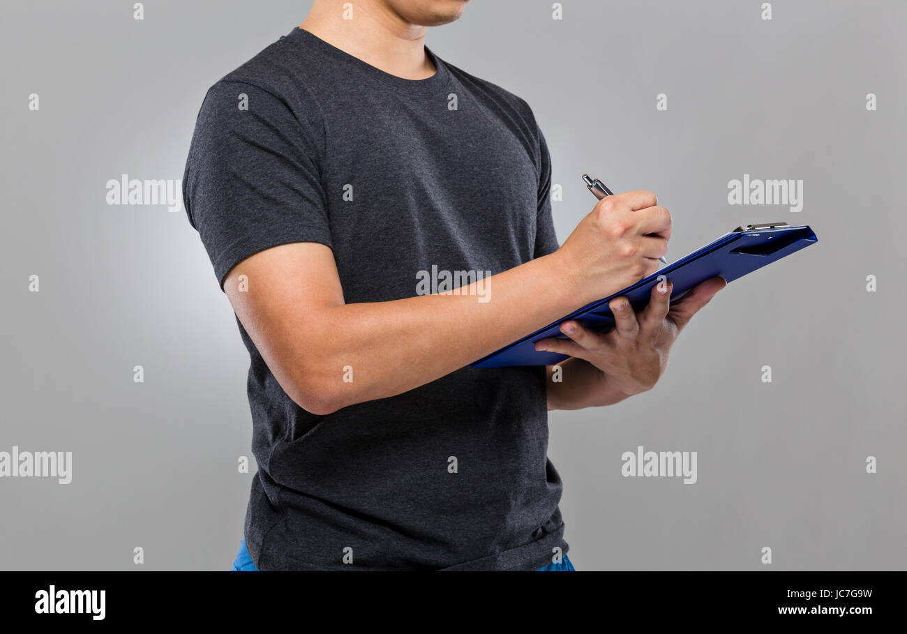 Man write on clipboard Stock Photo - Alamy