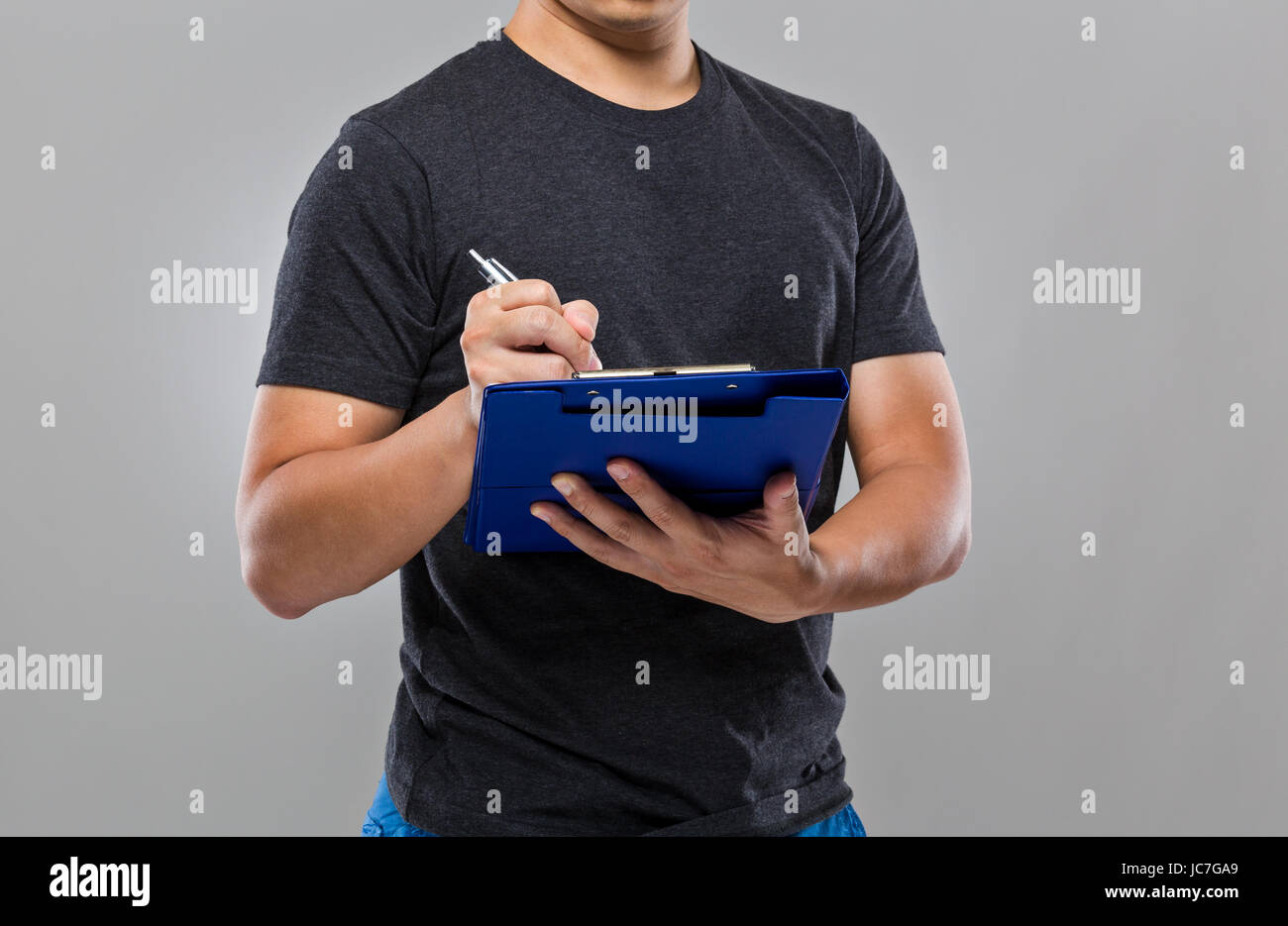 Man write on clipboard Stock Photo - Alamy