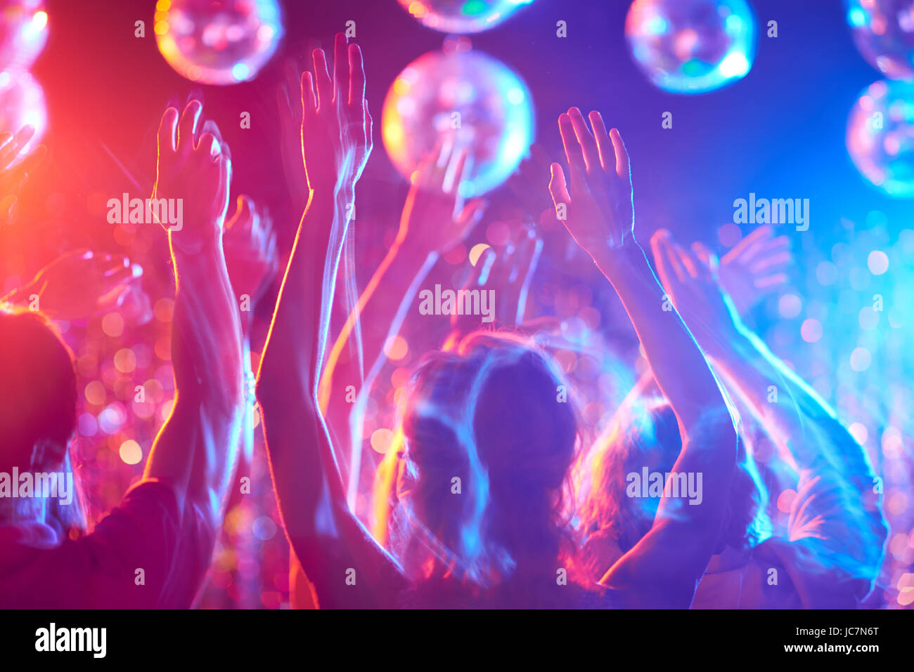 Crowd of young people dancing in night club Stock Photo - Alamy