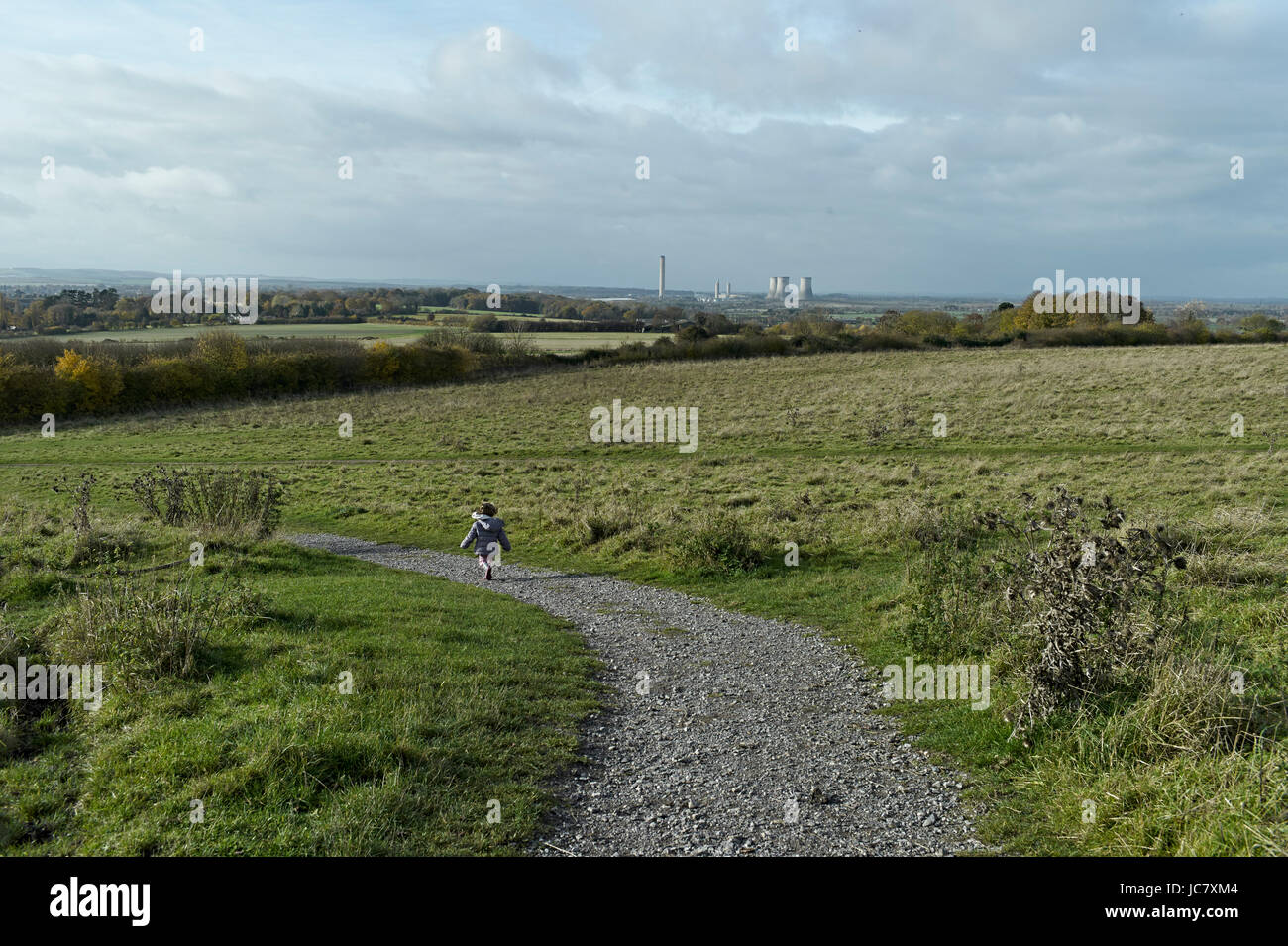 Oxfordshire, child walks past Wittenham Clumps is the common name for a pair of wooded chalk hills in the Thames Valley Stock Photo