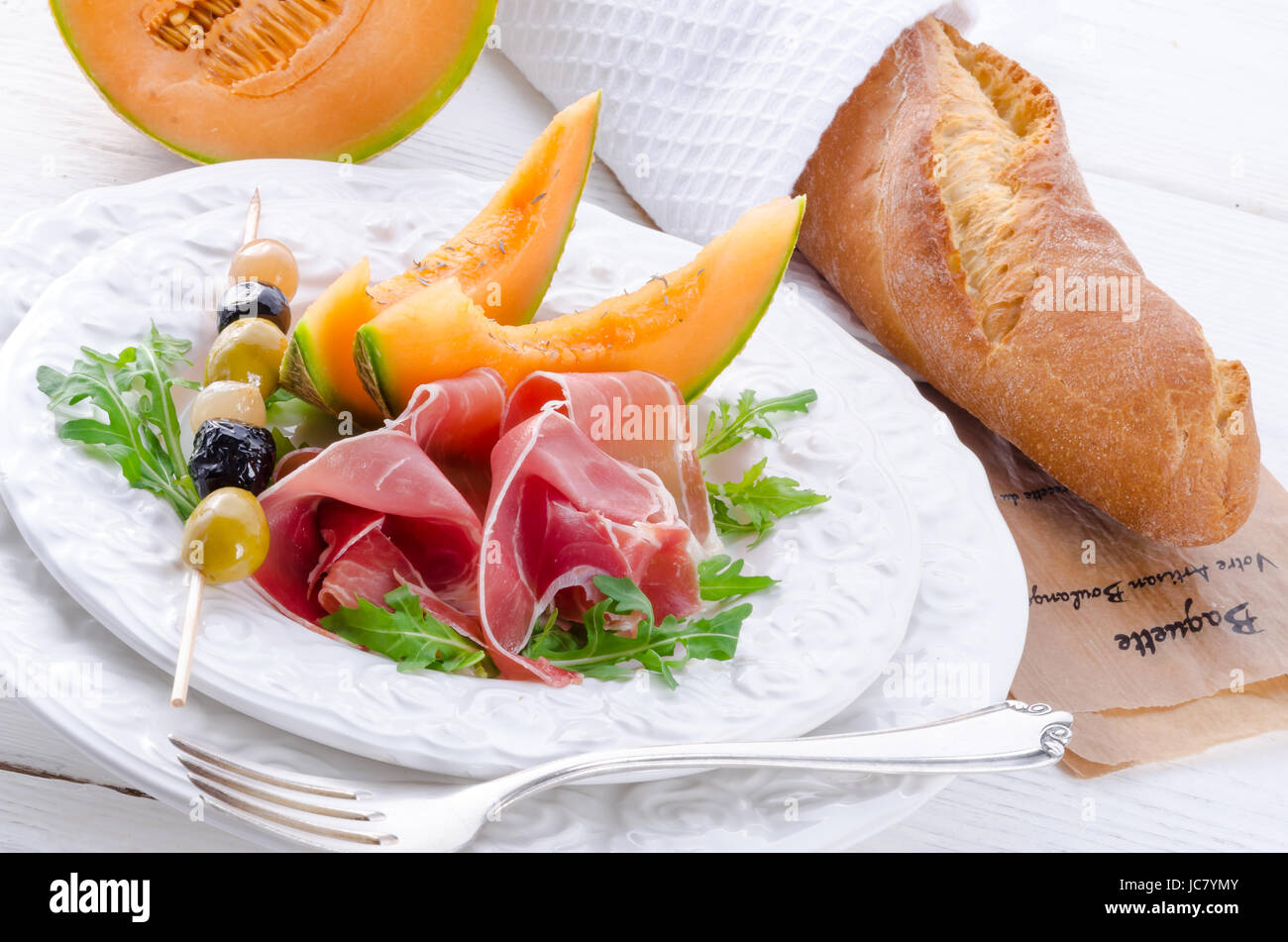 Ham with melon and olives Stock Photo