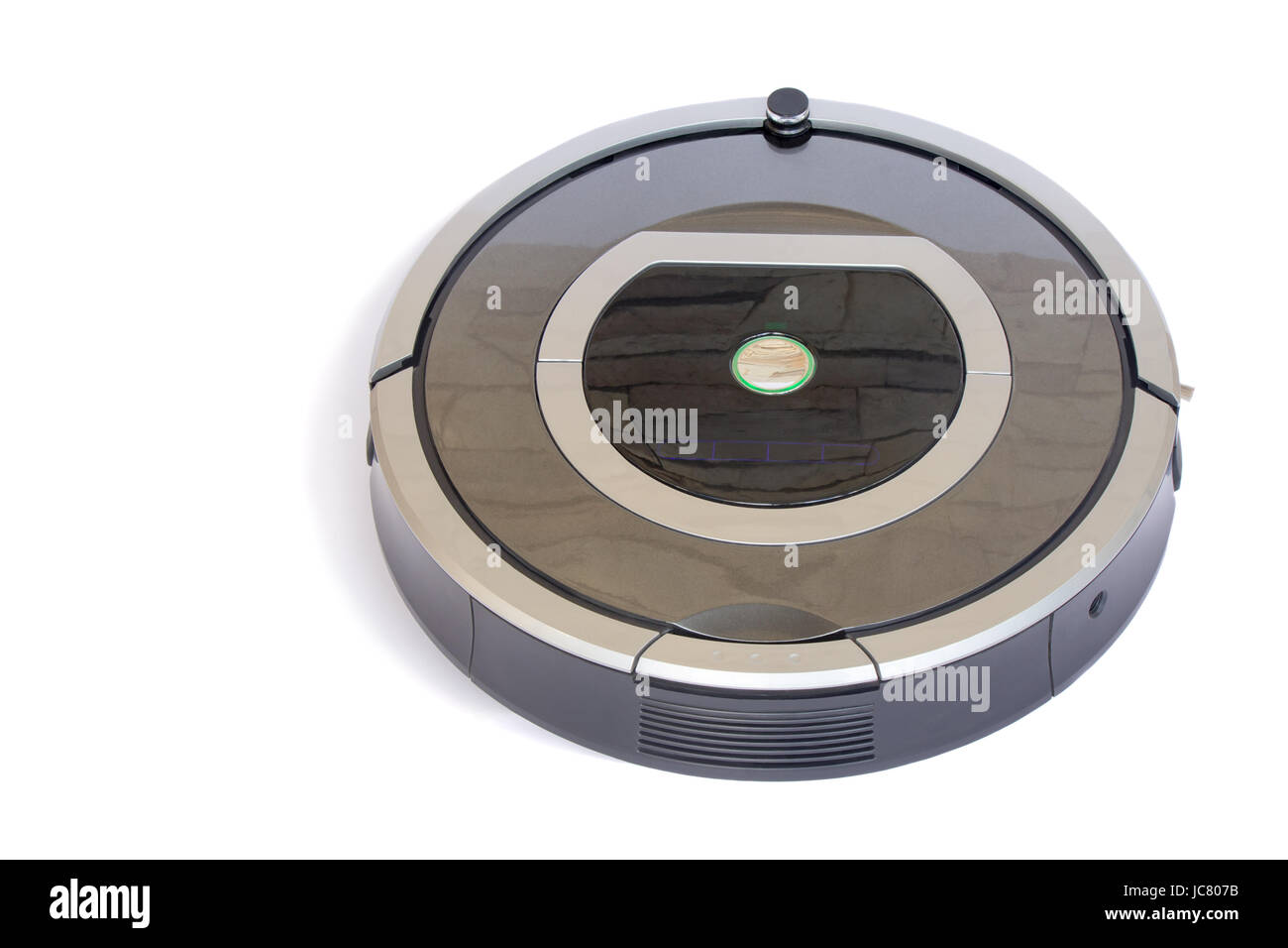 The automated robot vacuum cleaner of a roundish form, can make cleaning in hard-to-reach spots. It is presented on a white background. Stock Photo