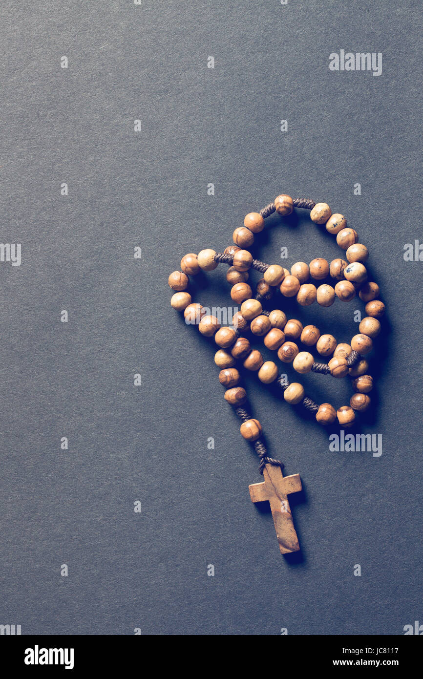 wooden rosary beads on black background Stock Photo - Alamy