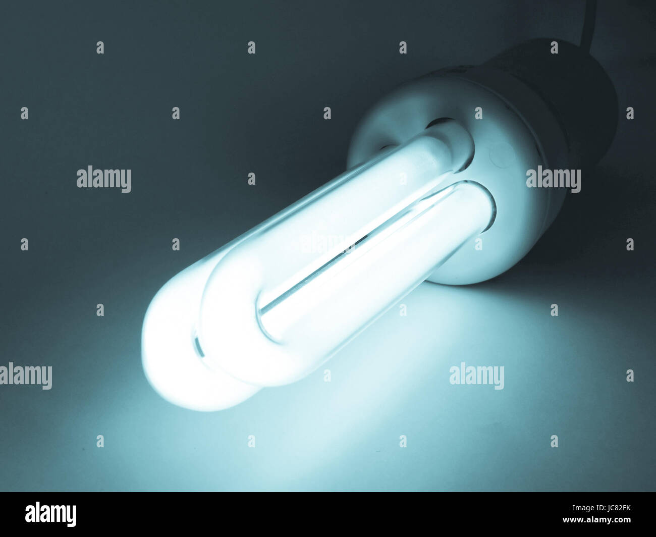 Compact fluorescent light bulb ecological low carbon cool cyanotype Stock Photo Alamy