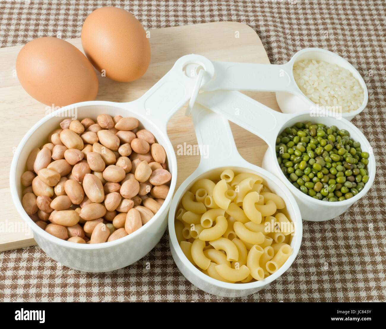 Food Ingredient, Raw Pasta, Rice, Peanuts, Mung Beans and Egg High in Carbohydrate and Protein. Stock Photo