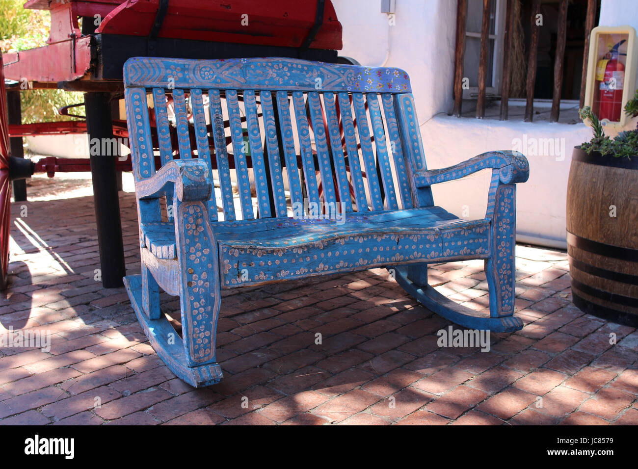 A hand crafted Mexican bench. Old Wood Carved and Painted Rustic Bench. Old Town Market, San Diego, California USA Stock Photo