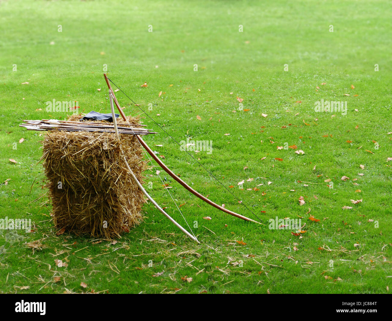 leaning bow and arrows on straw bales Stock Photo