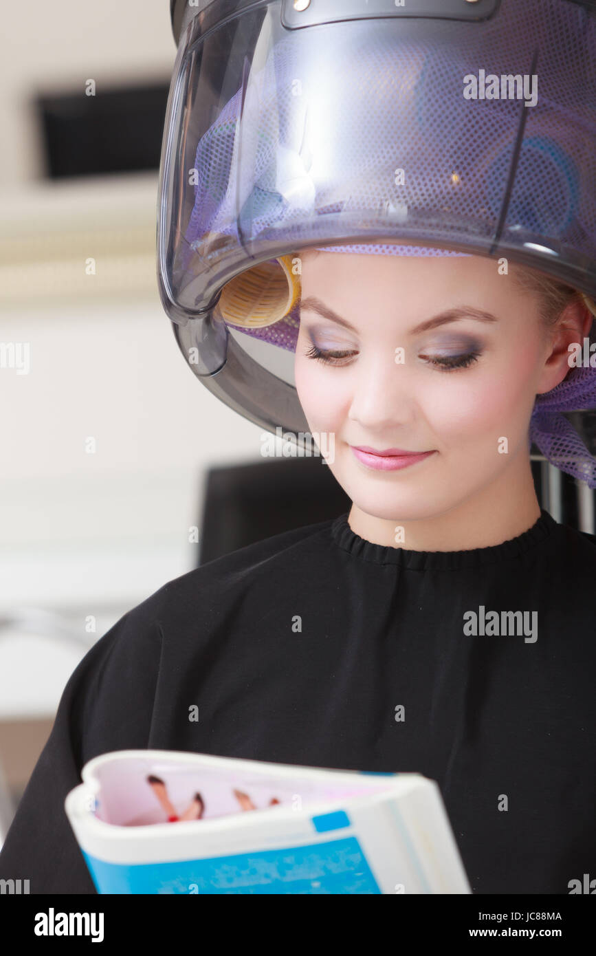 Young Woman Female Client Reading Magazine In Hairdressing Beauty