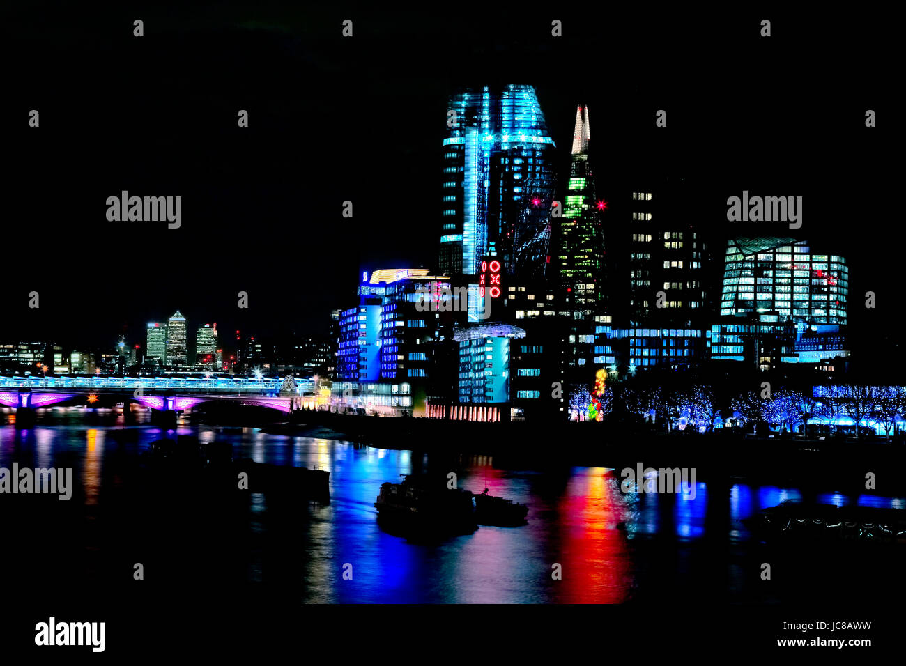night shot of river thames showing all illuminations and new buildings