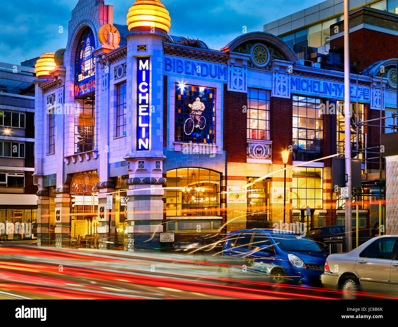 michelin building illuminated at night in london with traffic trails Stock Photo