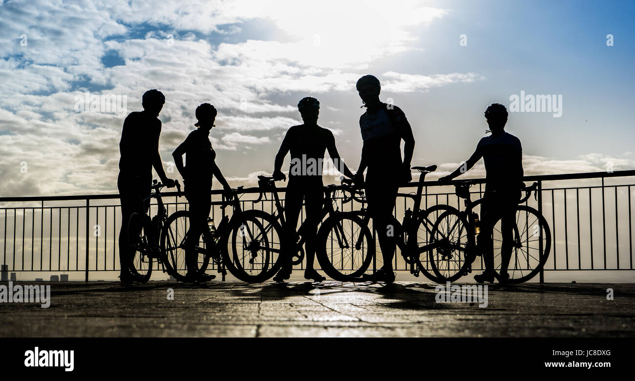 Group of bike riders stop to check the view from Mt Cootha Brisbane Australia Stock Photo