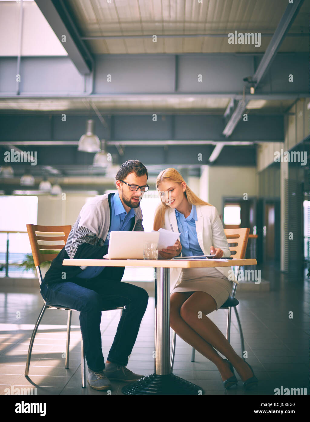 Two business partners working with documents at meeting Stock Photo - Alamy