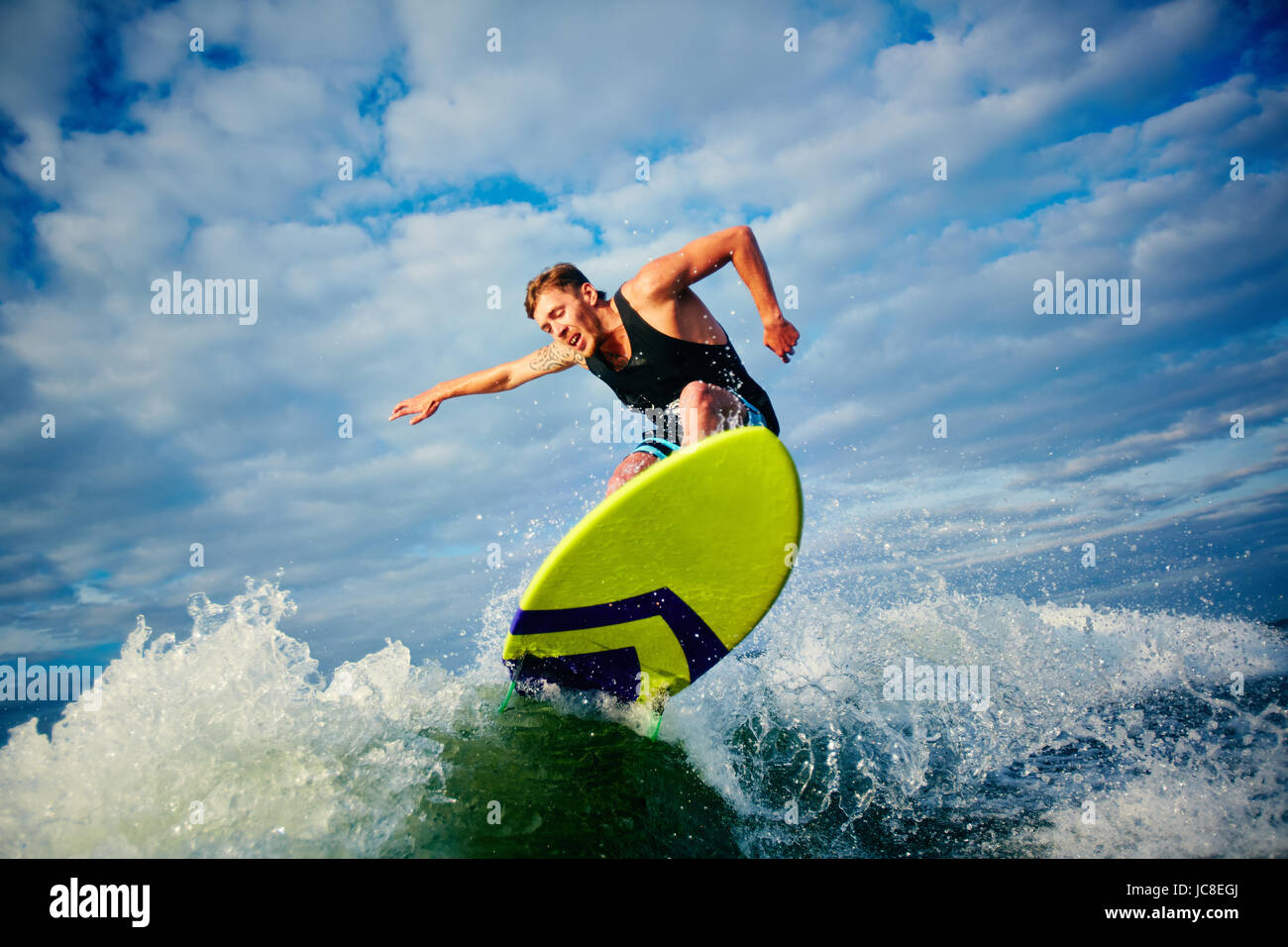 Male surfer riding on board in summer Stock Photo - Alamy