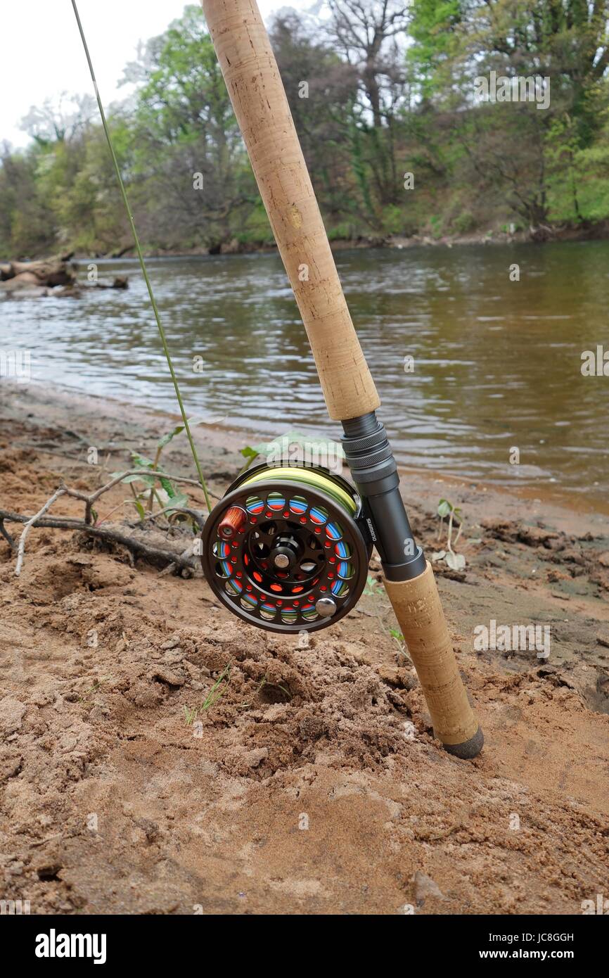 The butt section and real of a two handed salmon fishing rod setup at the  side of a Scottish river Stock Photo - Alamy