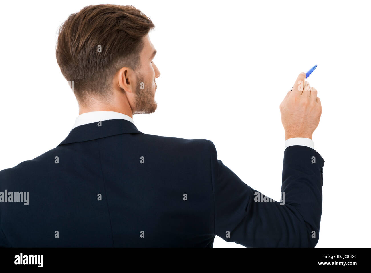 Stilvoller junger Geschäftsmann bei einer Präsentation eine Auswahl zu treffend oder etwas zeigend mit einem Stift in der Hand isoliert auf weißem Hintergrund Stock Photo