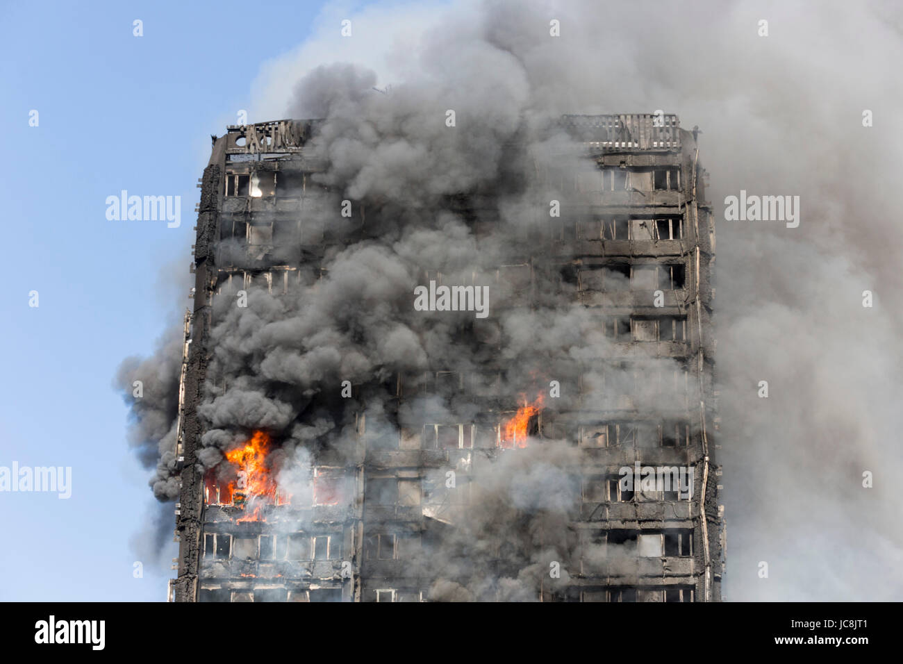 London, UK. 14th June, 2017. Fire is still burning inside the tower at 9am. At least 50 people have been taken to five hospitals for treatment as hundreds of residents in the 24-storey, 120 flat, Grenfell Tower in North Kensington have been evacuated from their flats in the building that caught fire just after 1.15am. Many casualties are expected. Credit: Bettina Strenske/Alamy Live News Stock Photo