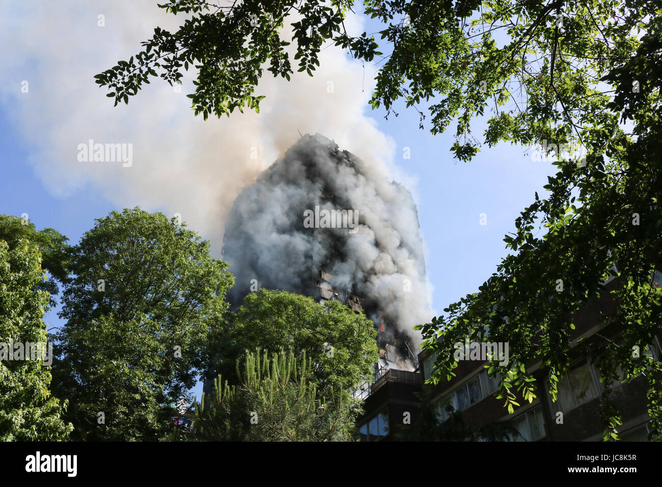 London, UK. 14th June, 2017. Grenfell Tower, A high rise residential block in Latimer road West London is engulfed by huge flames and smoke by a fire which started at nights as residents are evacuated. As yet there are no reports of casualties. Credit: amer ghazzal/Alamy Live News Stock Photo