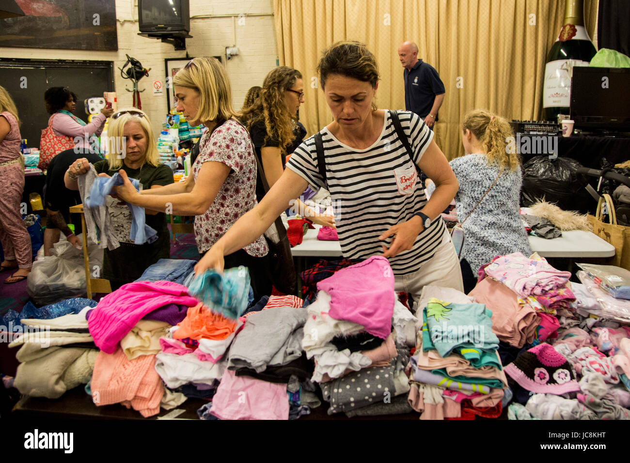 London, UK. 14 June 2017. After the fire in the 24-storey, 120 flat, Grenfell Tower in North Kensington, Notting Hill, residents help out at the Maxilla Social Club where food and clothes donations are sorted. Photo: Bettina Strenske/Alamy Live News Stock Photo